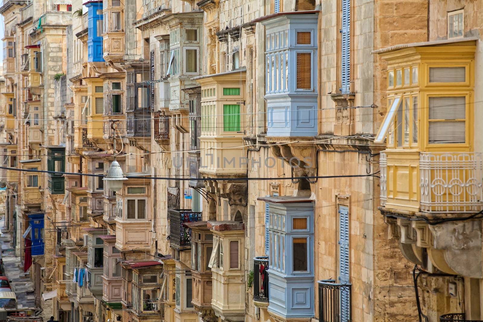 A multitude of colourful wooden balconies in one of the streets of Valletta