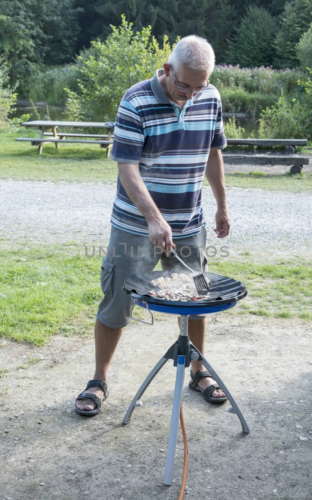 man coocking food with gas comfort on the camping