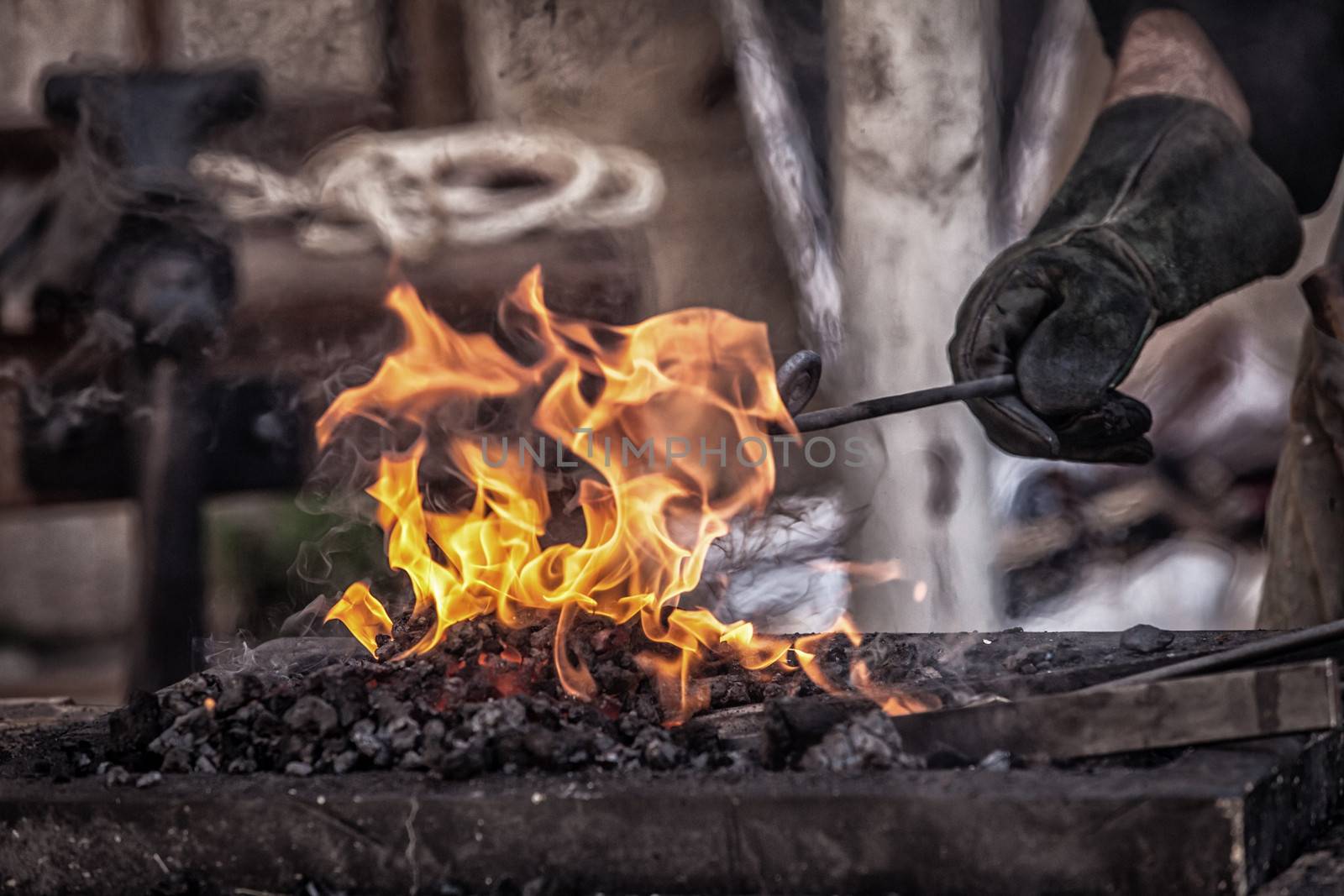 Detail shot of metal being worked at a blacksmith forge