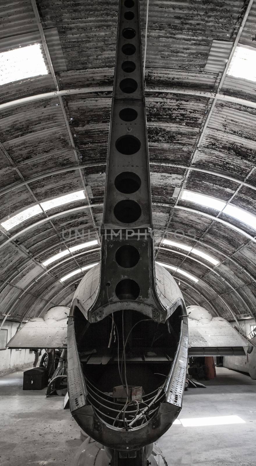 Tail section of an old aircraft lying in a hangar
