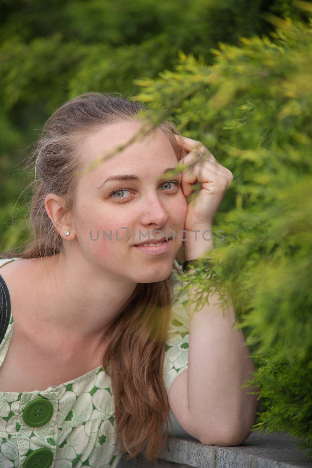 Beautiful young woman in park in summer