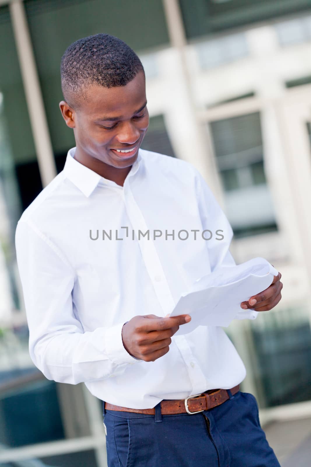 smiling successful businessman with tablet pc outdoor in summer 