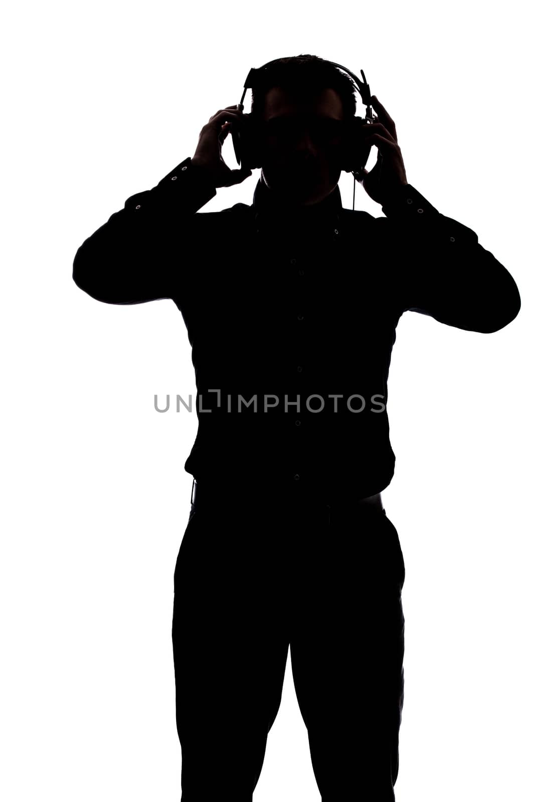 Man listening to music with headphones in silhouette isolated over white background