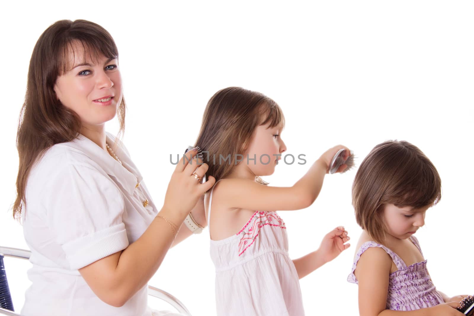 Mother and two daughters combing hair to each othre by Angel_a