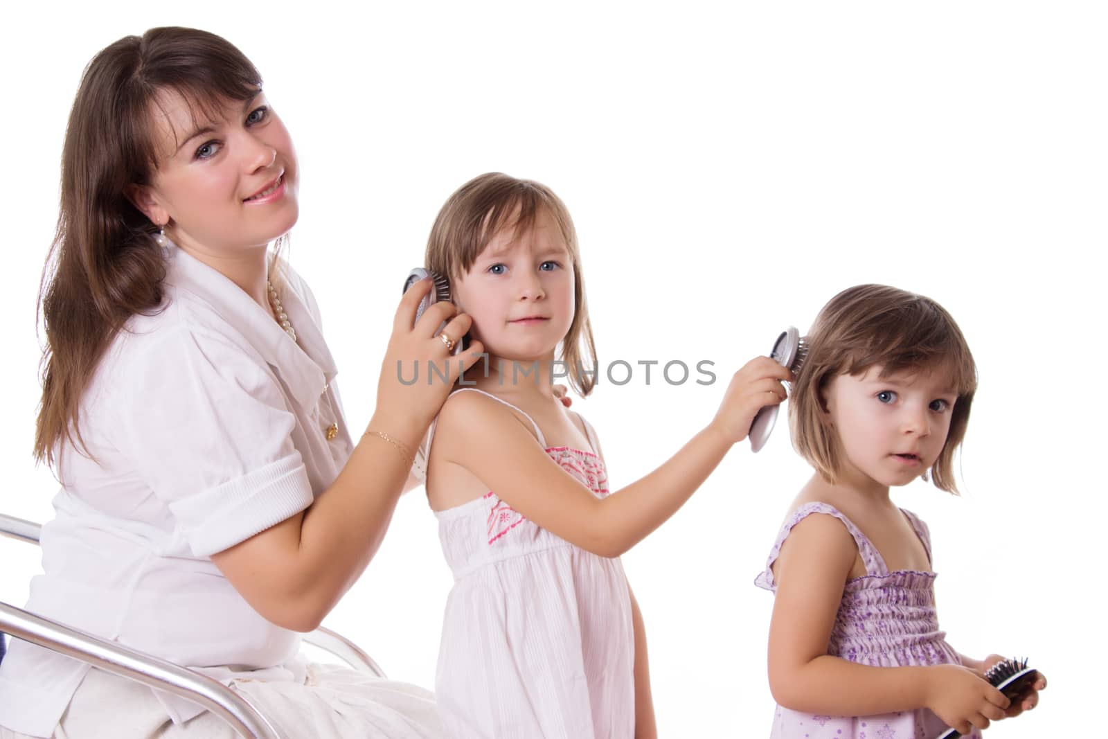 Mother and two daughters combing hair to each othre by Angel_a