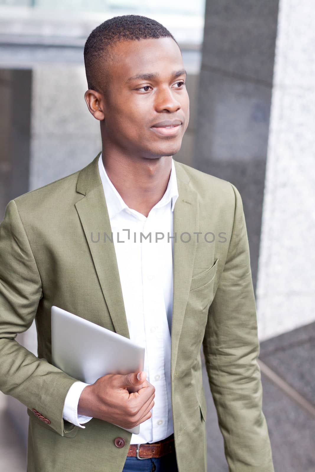 smiling successful businessman with tablet pc outdoor in summer 