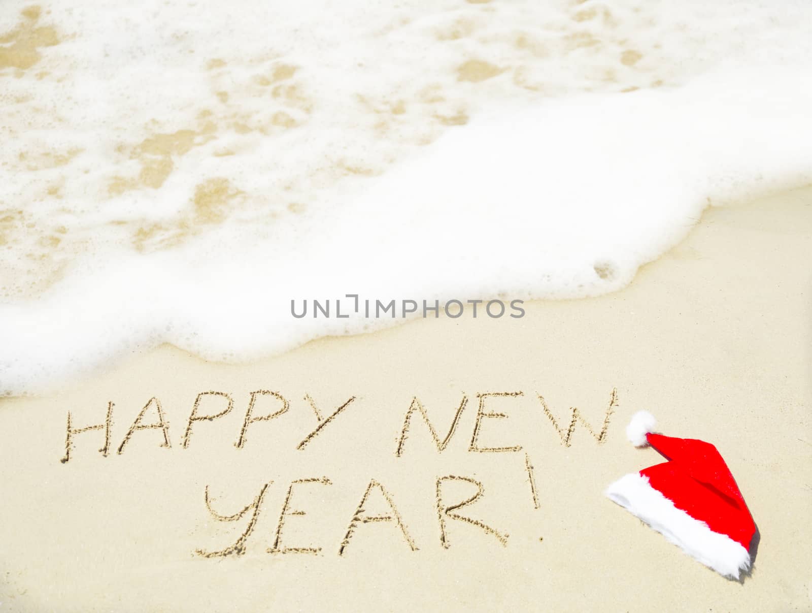 Sign "Happy new year" on the sand - holiday concept by EllenSmile