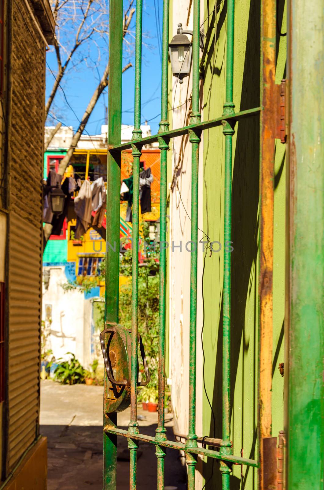 Green door leading to an old dilapidated patio in Buenos Aires