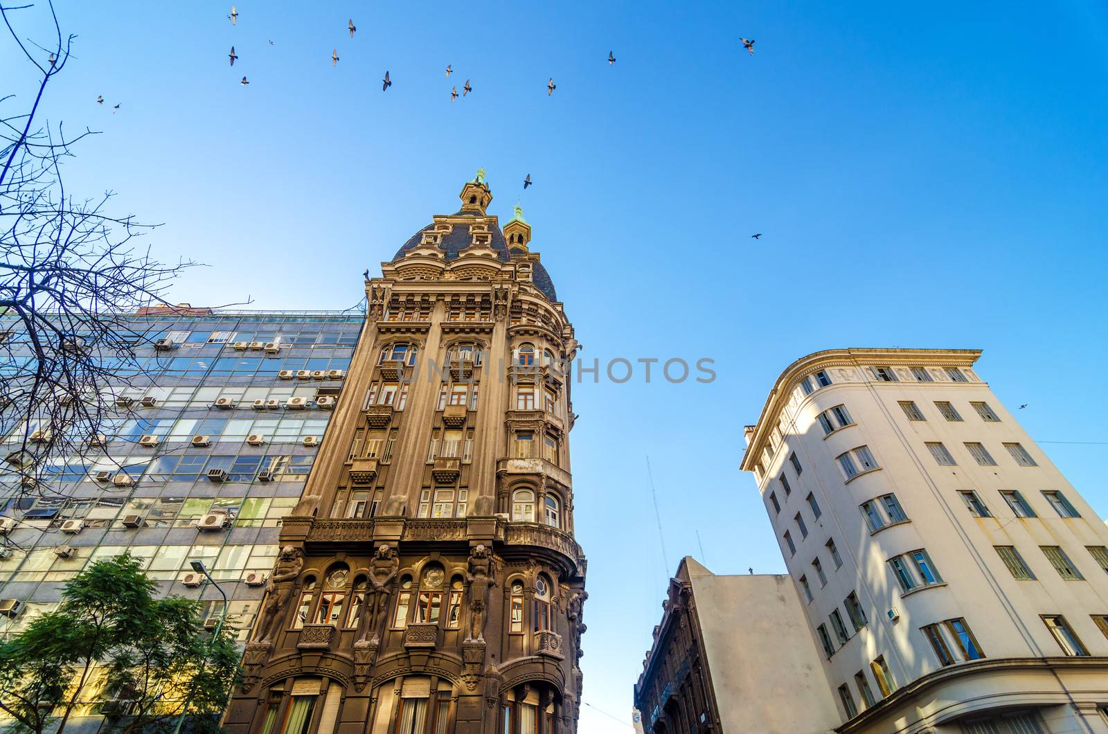 Old historic apartment building in San Telmo neighborhood of Buenos Aires, Argentina with birds flying above