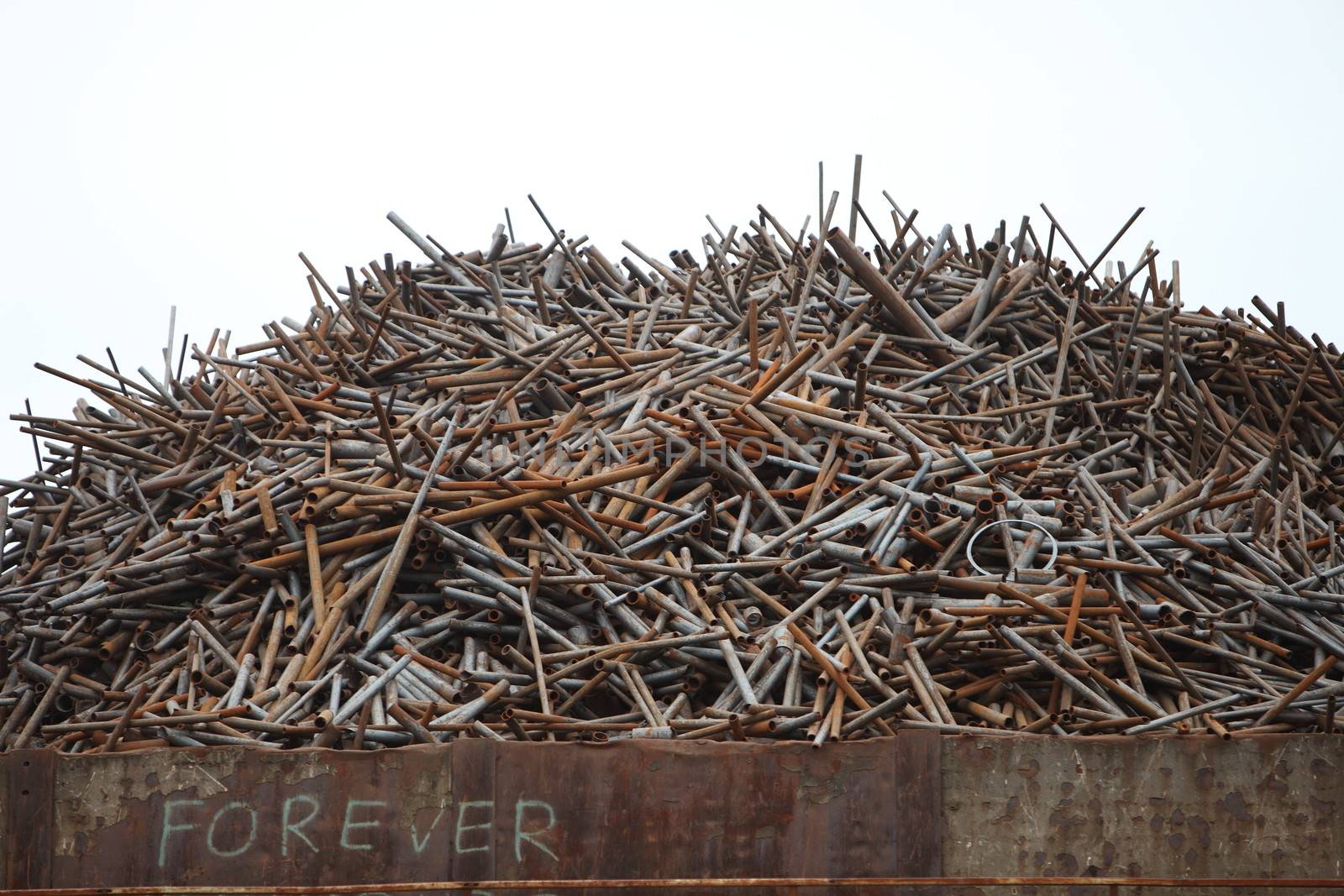 Pile of old rusty industrial metal in a container waiting to be disposed of