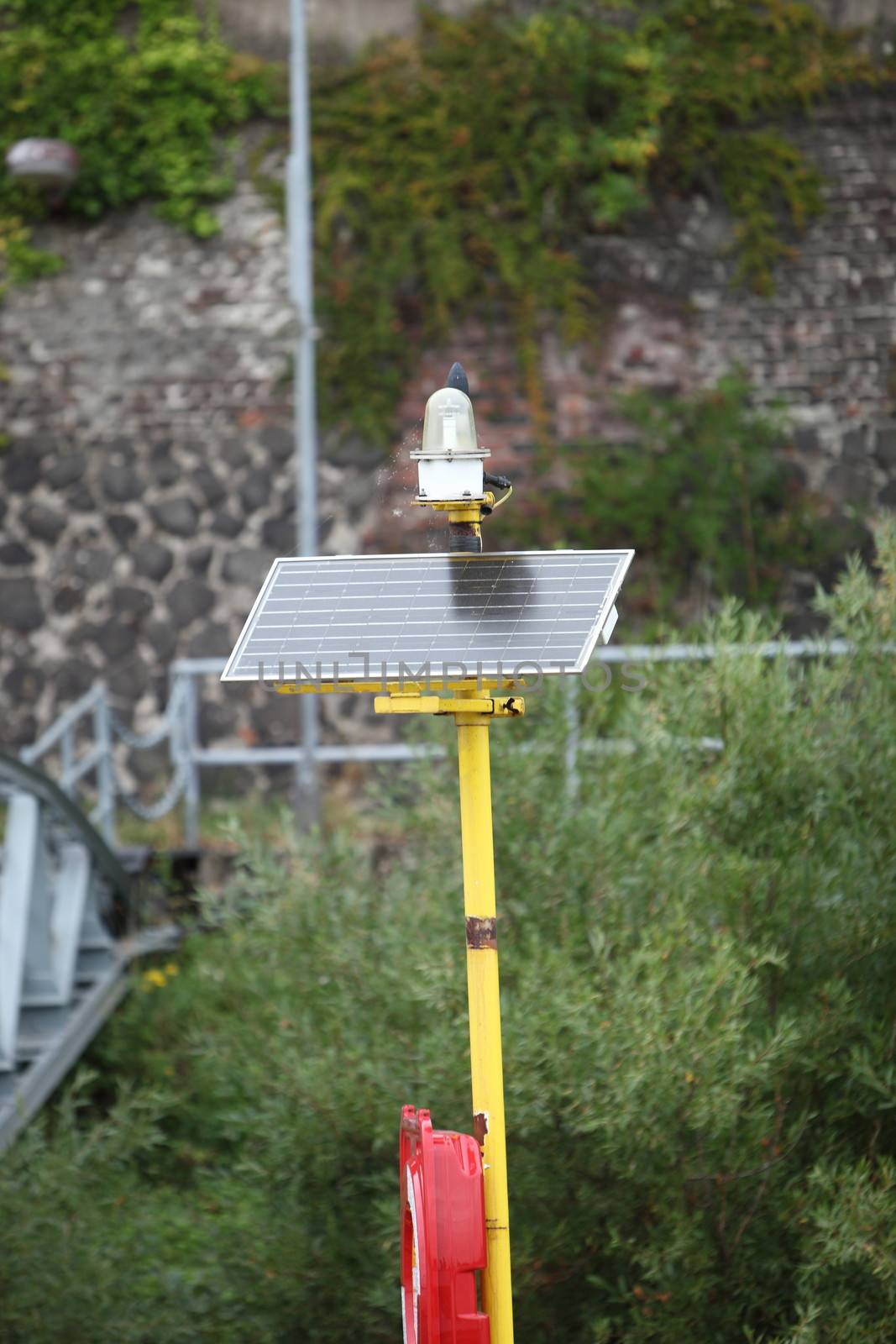 Solar powered portable light with a battery to store the converted electrical power used as a warning light for traffic or to warn of a hazard
