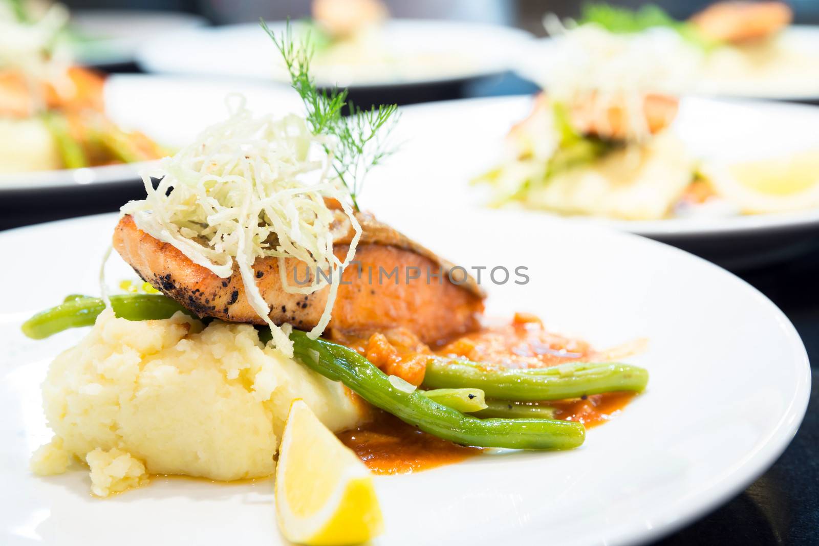 gourmet Grilled Salmon Steak with baked potato and lemon meal