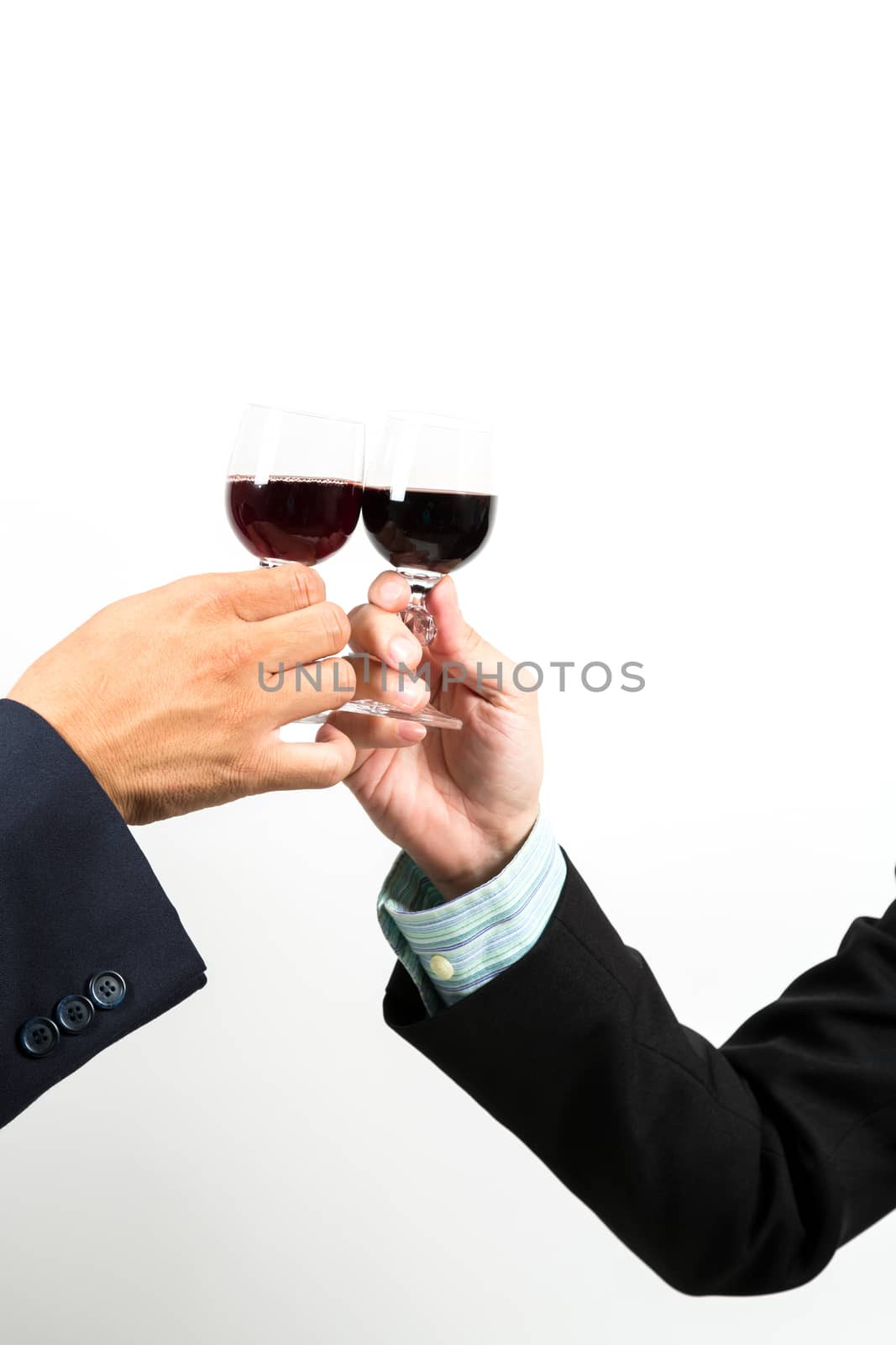 Close-up of human hands cheering up with flutes of wine