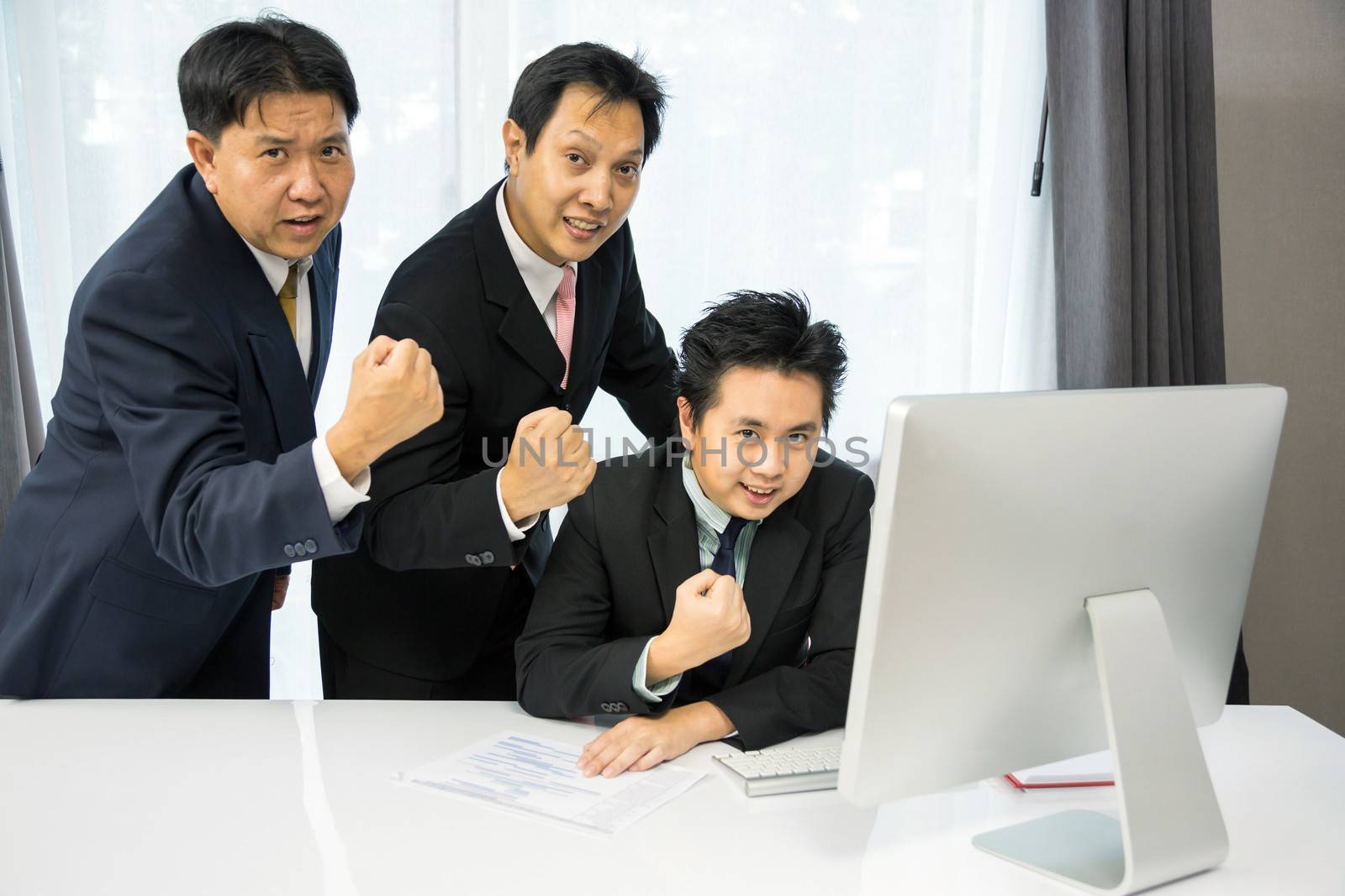 Team of businessmen analysis their business with computer desktop