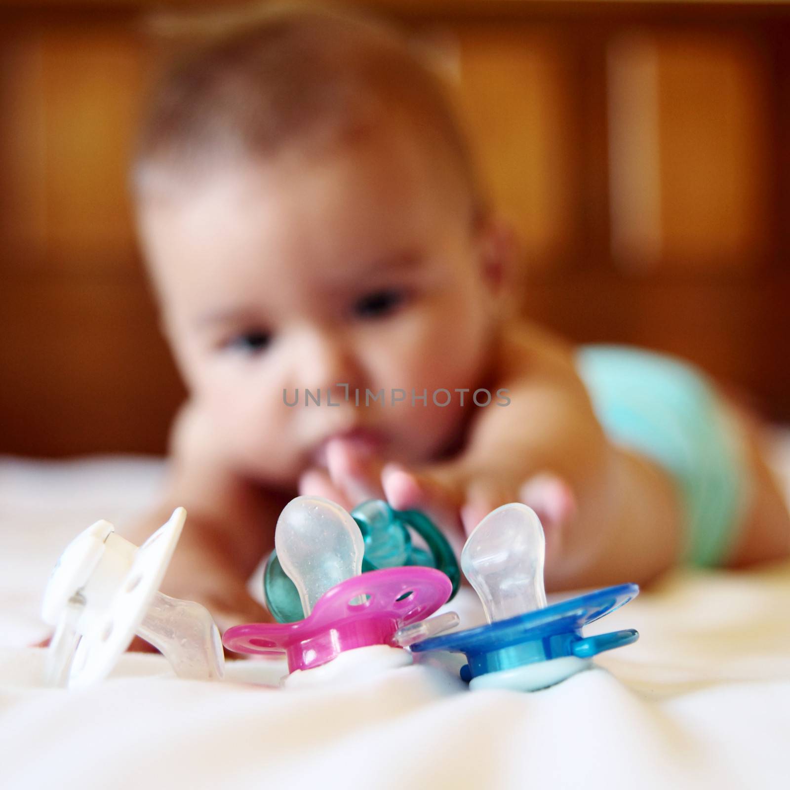 beautiful baby want to take her pacifiers