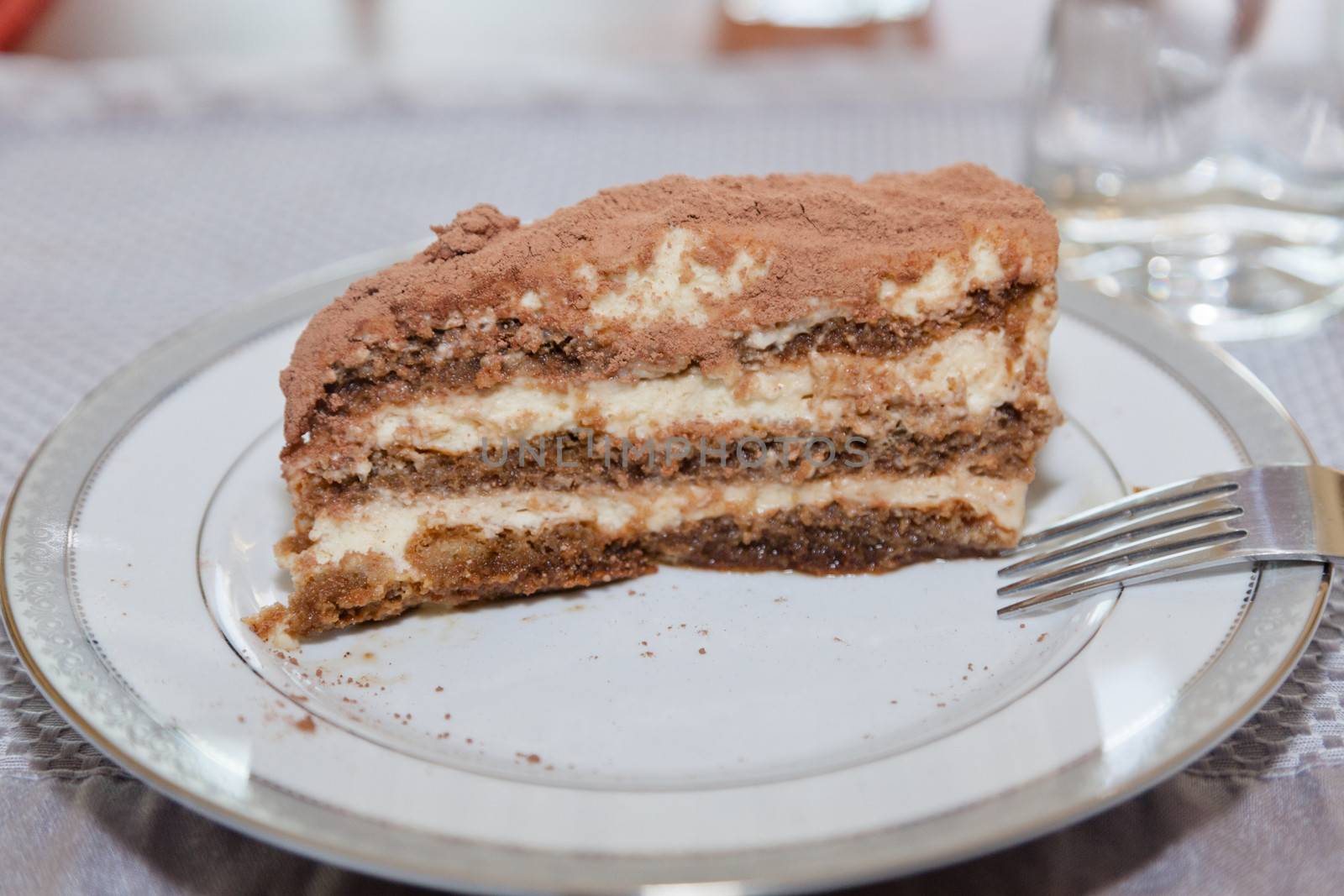 Tiramisu is made of biscuits dipped in coffee, layered with a whipped mixture of egg yolks and mascarpone, and flavored with liquor and cocoa.
