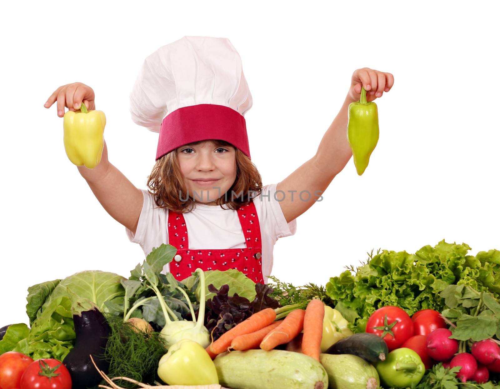 little girl cook holding peppers by goce
