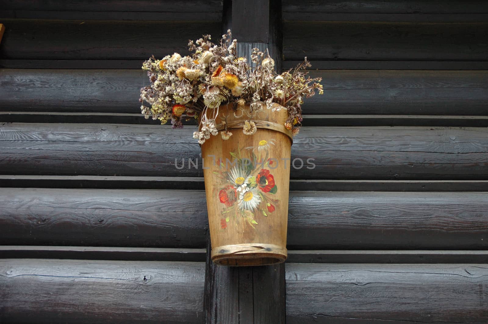 Wooden and painted plant pot on wooden wall