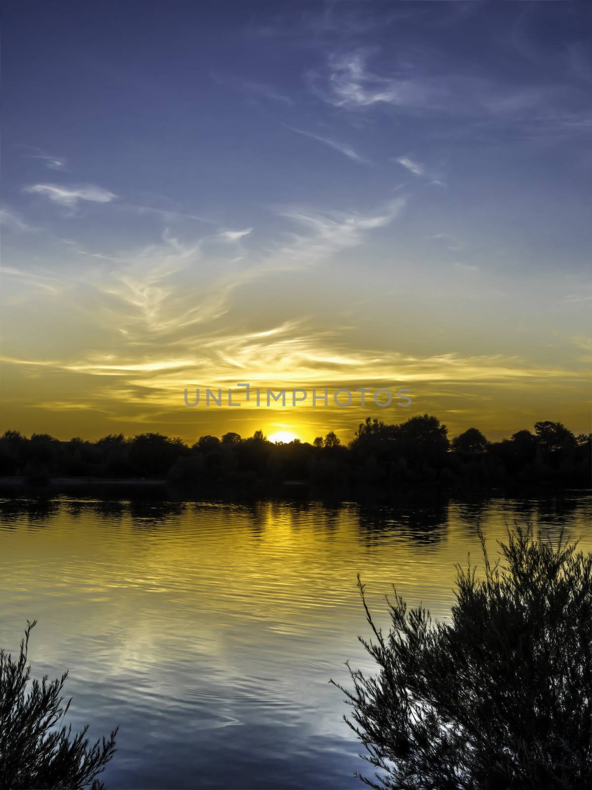 Sunset with blue and golden colors on a lake in Germany