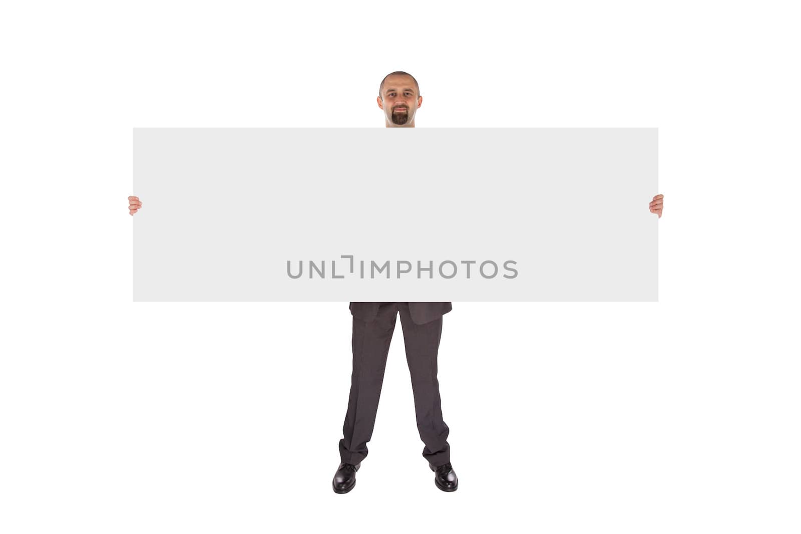 Smiling businessman holding a really big blank card, isolated on white
