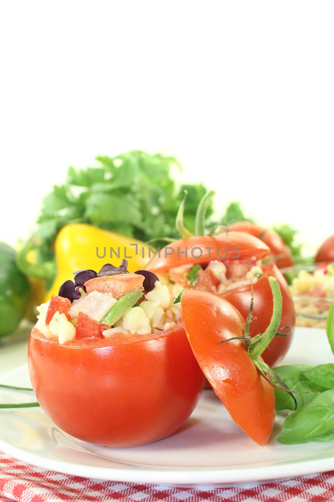 stuffed pasta salad with tomatoes and basil on a light background
