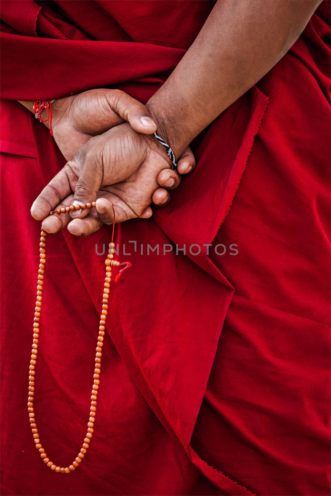 Tibetan Buddhism - prayer beads in Buddhist monk hands. Ladakh, India