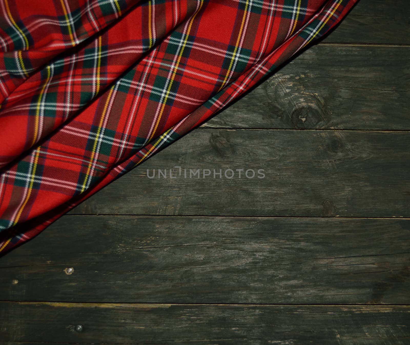 tartan textile on wooden background