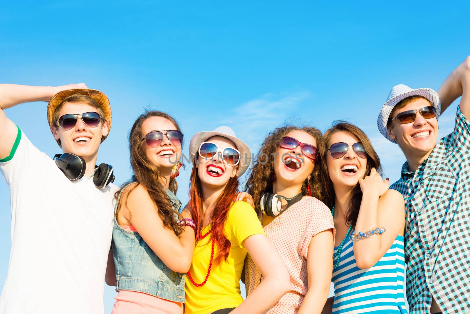 group of young people wearing sunglasses and hats hugging and standing in a row, spending time with friends