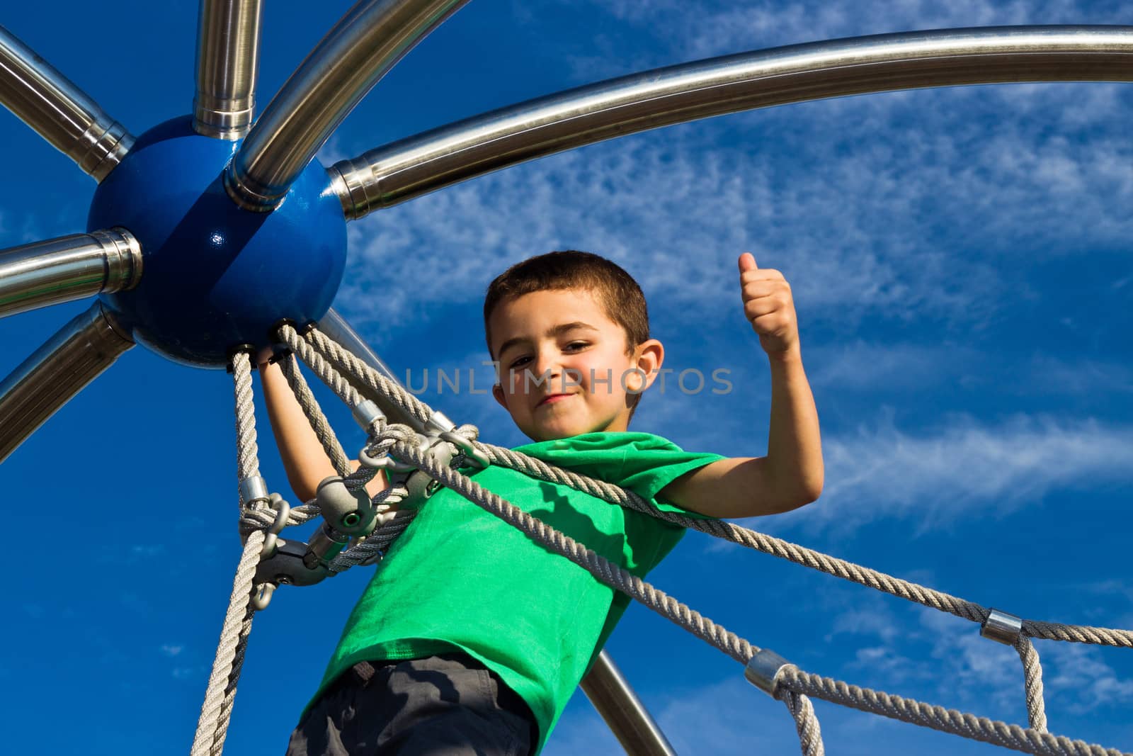 Child playing on the play structure in the park