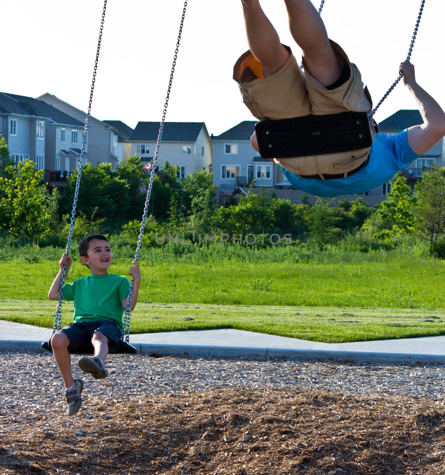 Family playing on the swing set