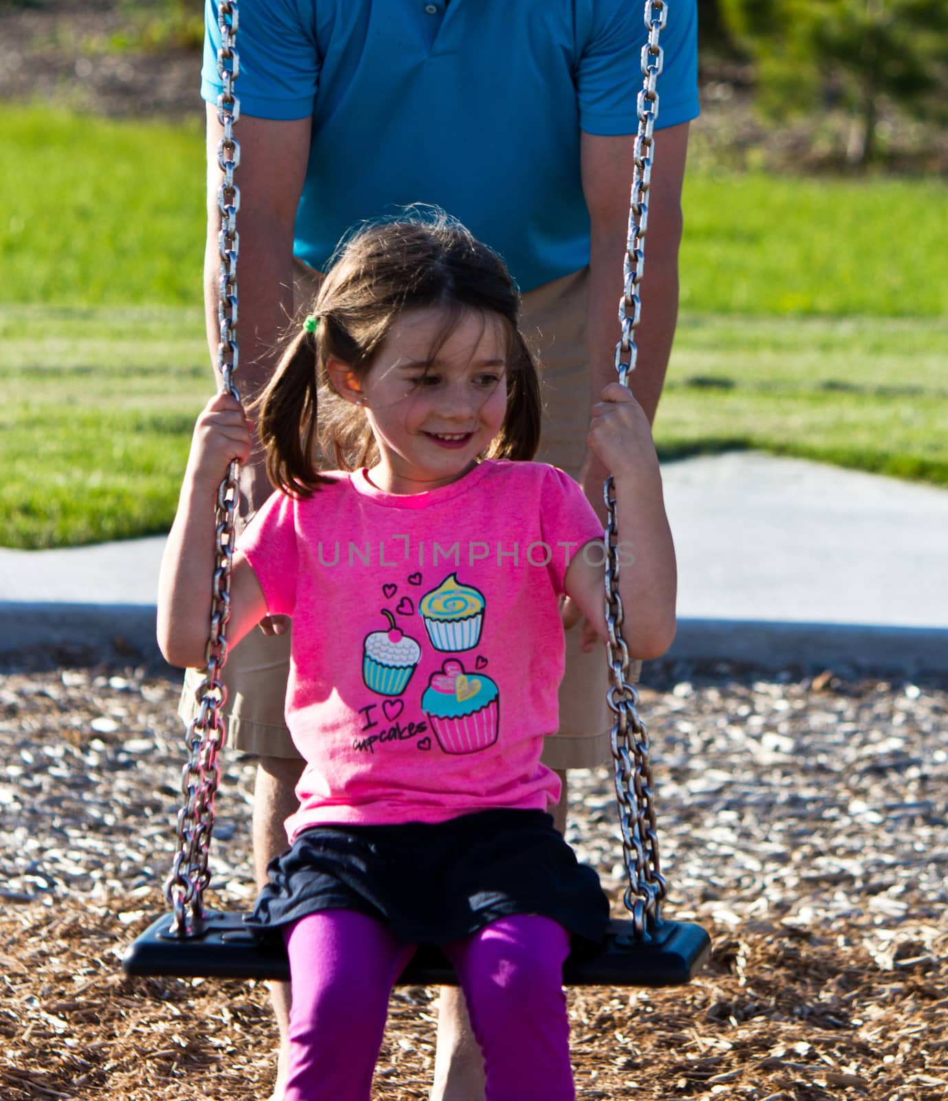 Family playing on the swing set