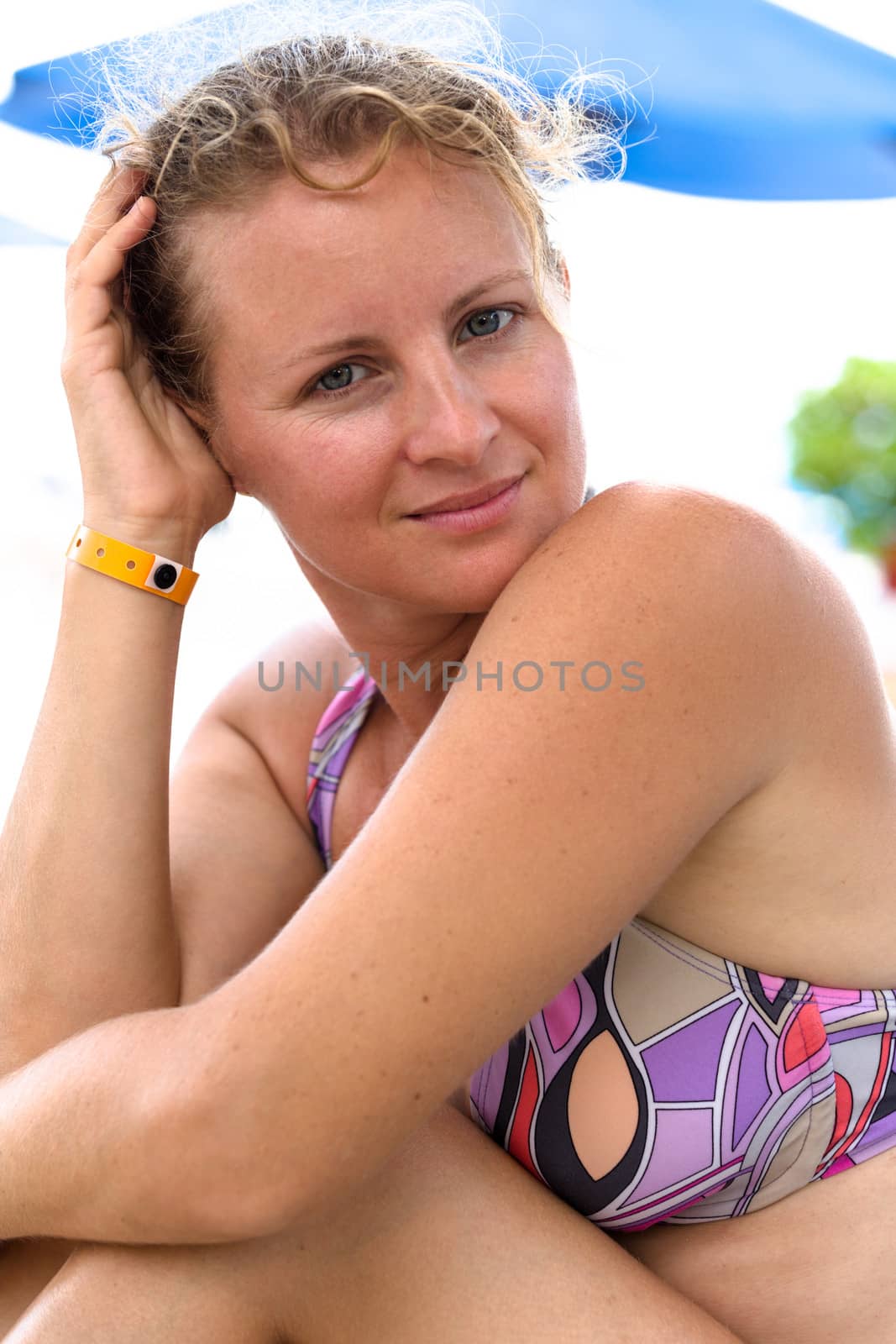 Woman with a bikiny looking at camera calmly and thoughtfully