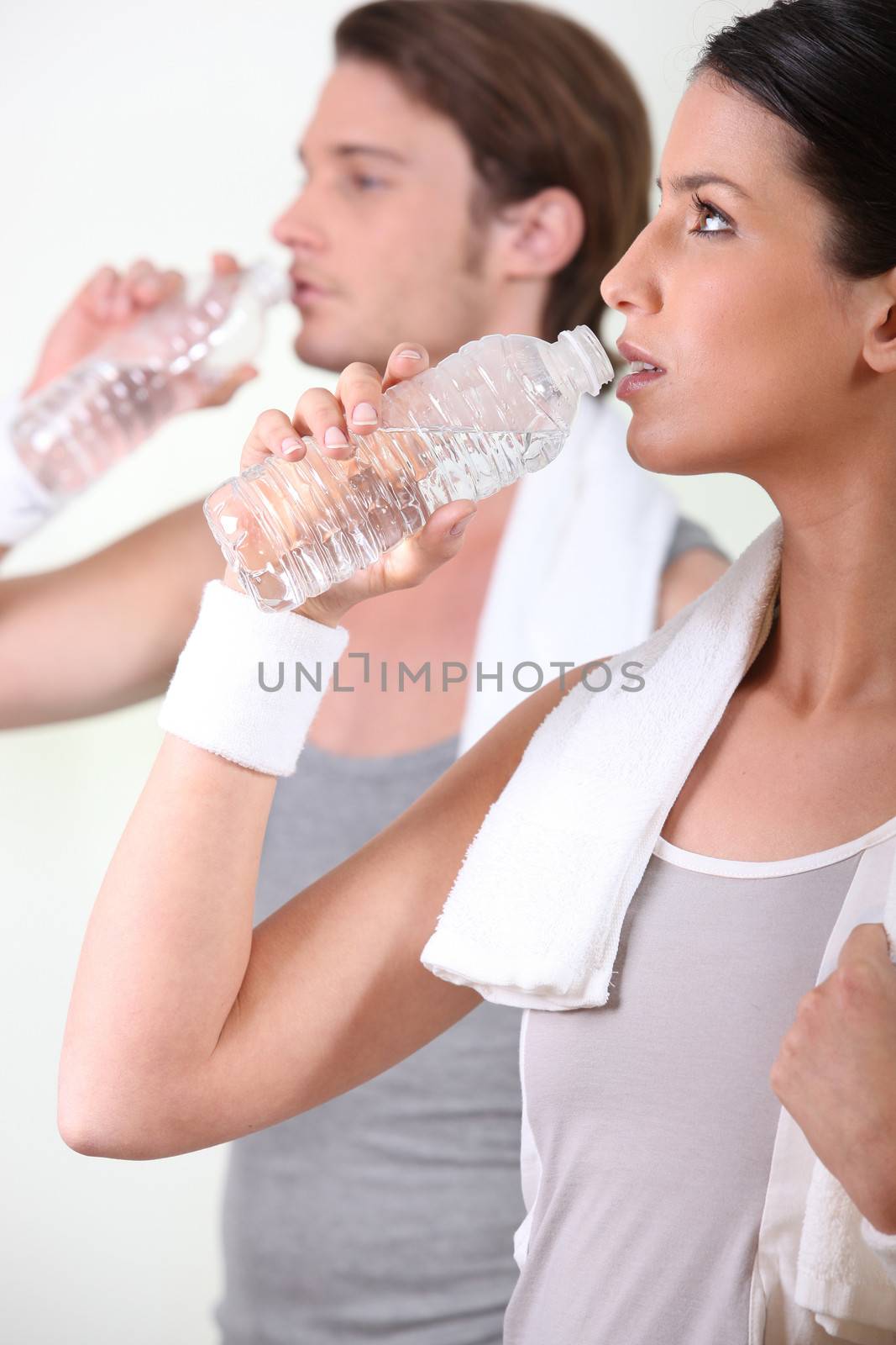 a couple drinking water after sport