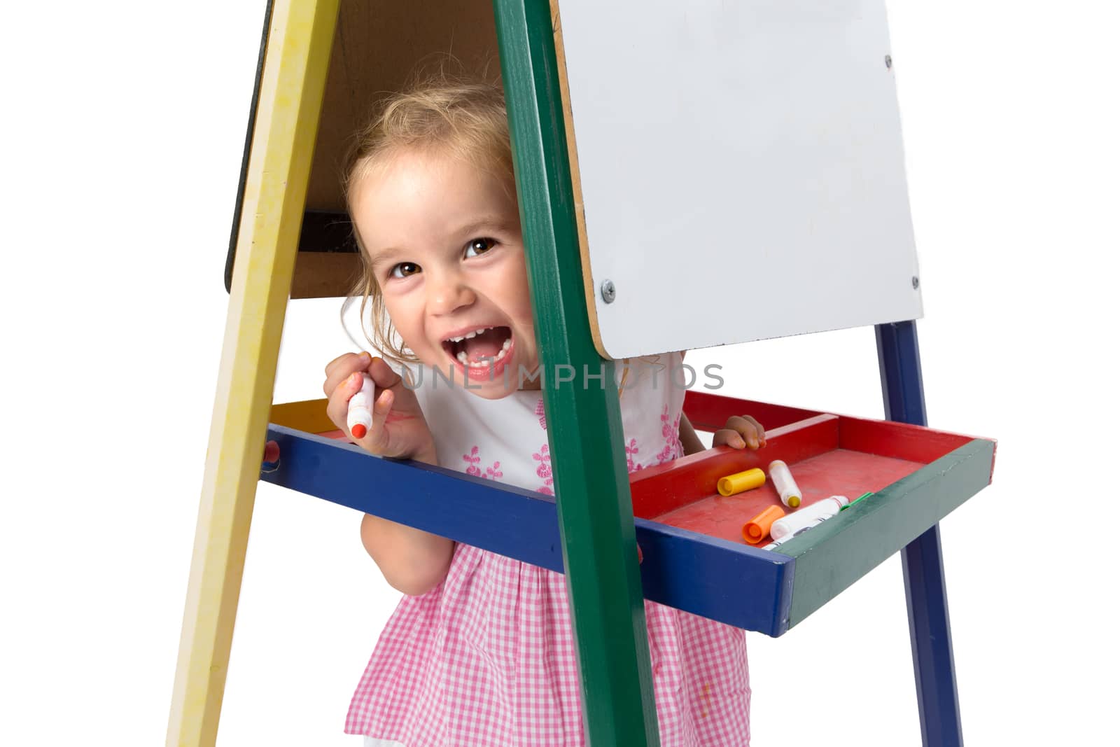 Girl smiling between whiteboard legs cheerfully and playfully, copy space on the whiteboard