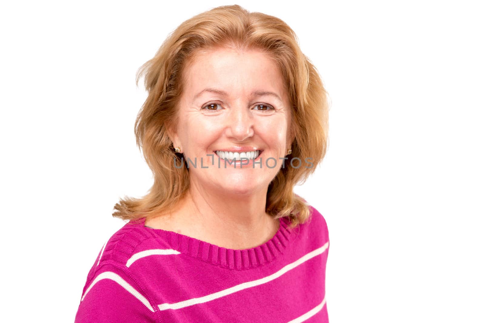 A blonde lady with pink sweater and greate great smile on her face perhaps feels good.