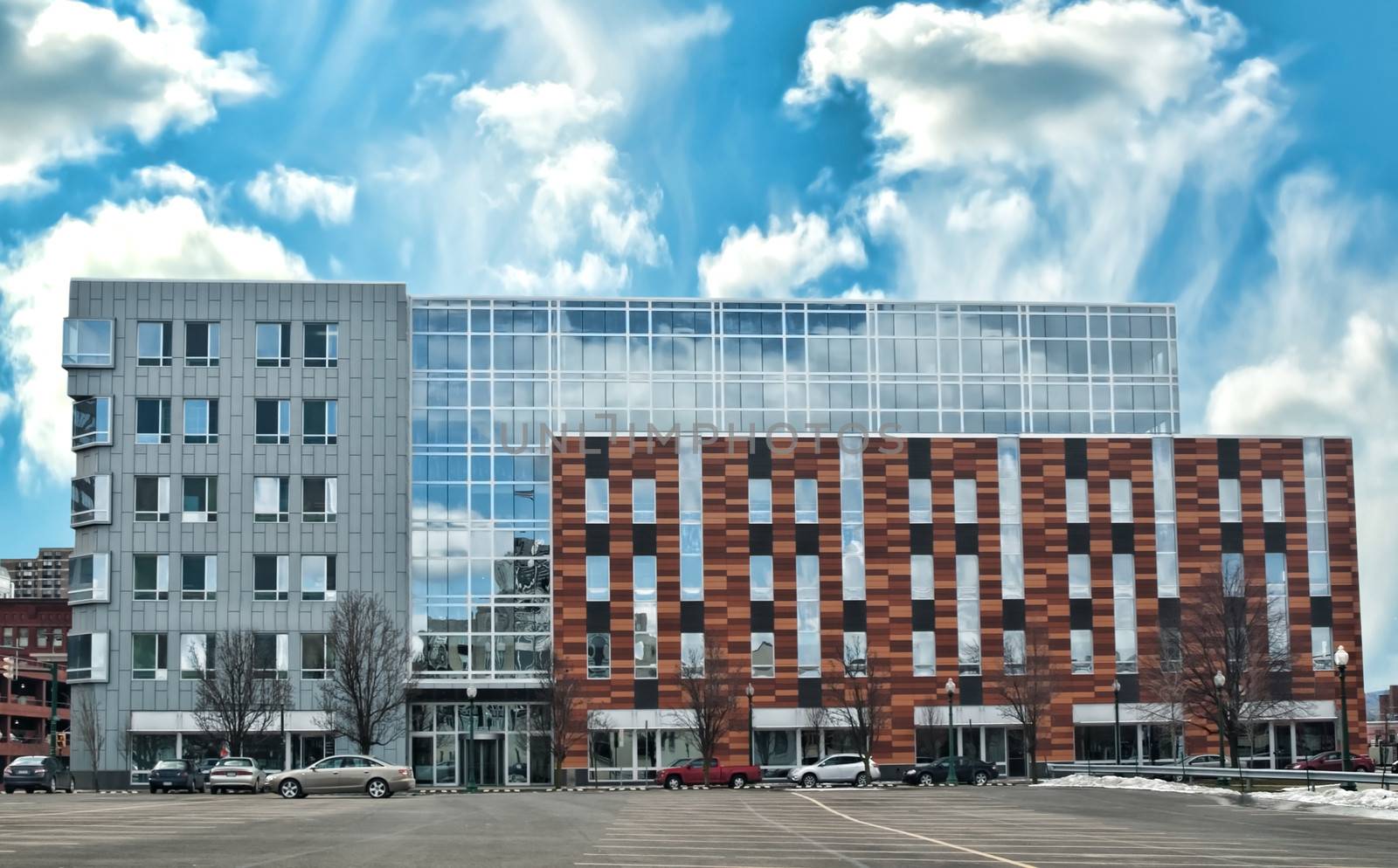 modern office builing with mirrored windows and sky reflection