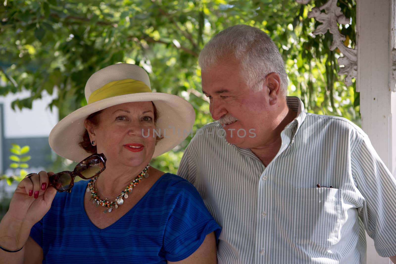 Senior couple, woman looking at camera her husband looking at her with love and trust