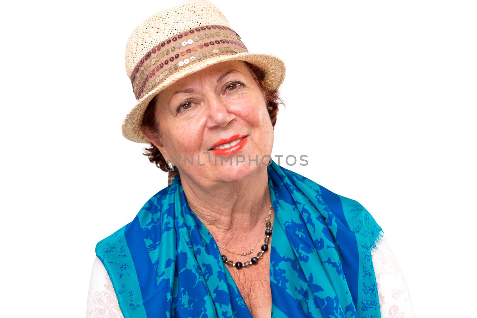 Senior lady giving a satisfied look with her hat and blue scarf on her shoulders.