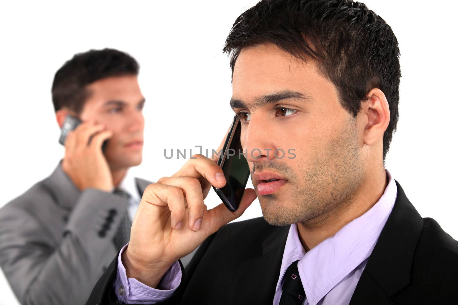 Young businessmen on the phone by phovoir