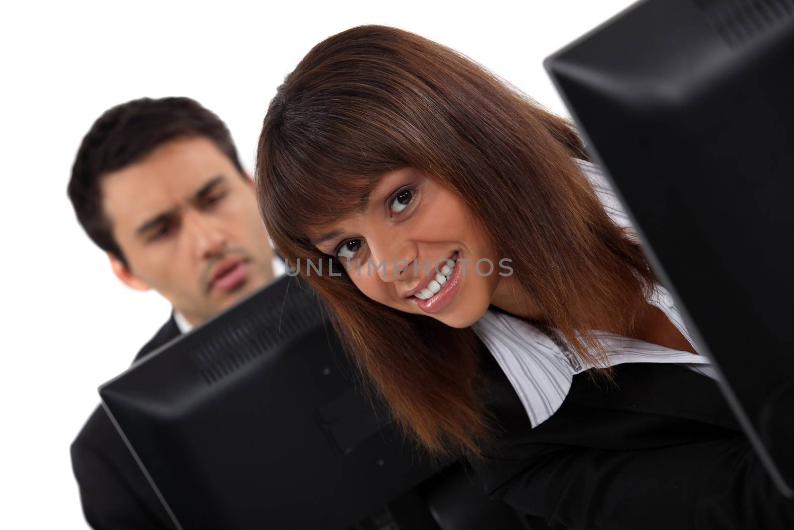 Two colleagues working in open-plan office