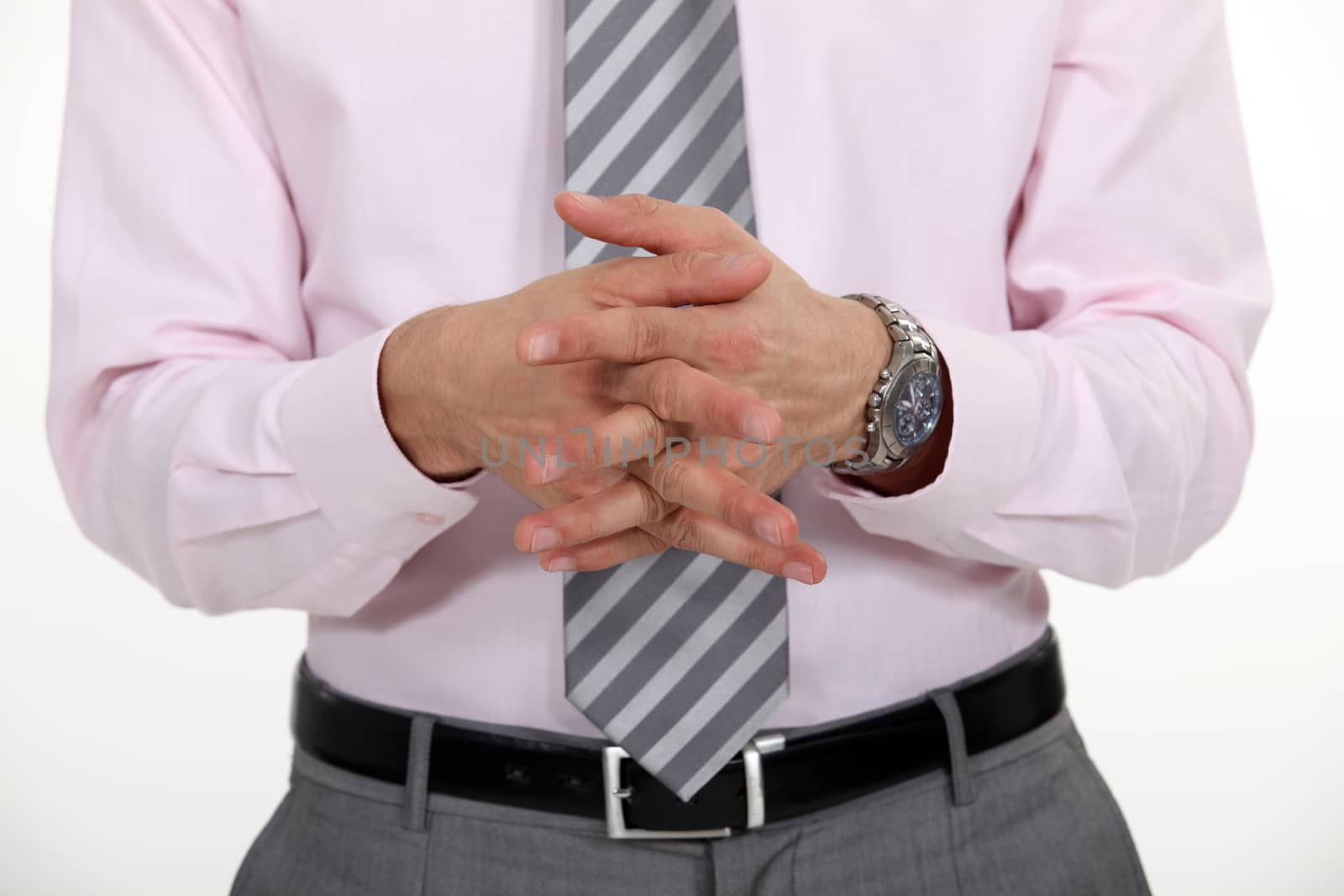 Businessman stood with hands clasped