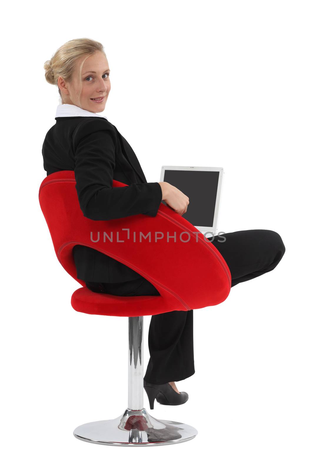 Businesswoman sitting in a funky chair with a laptop