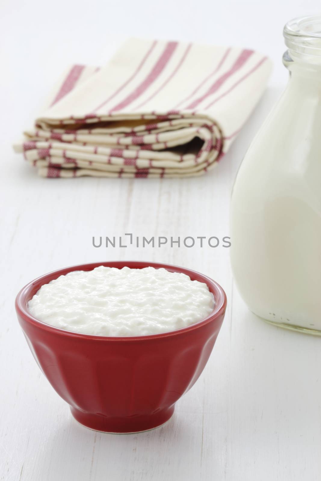 Cottage cheese and fresh milk on vintage french table linen.