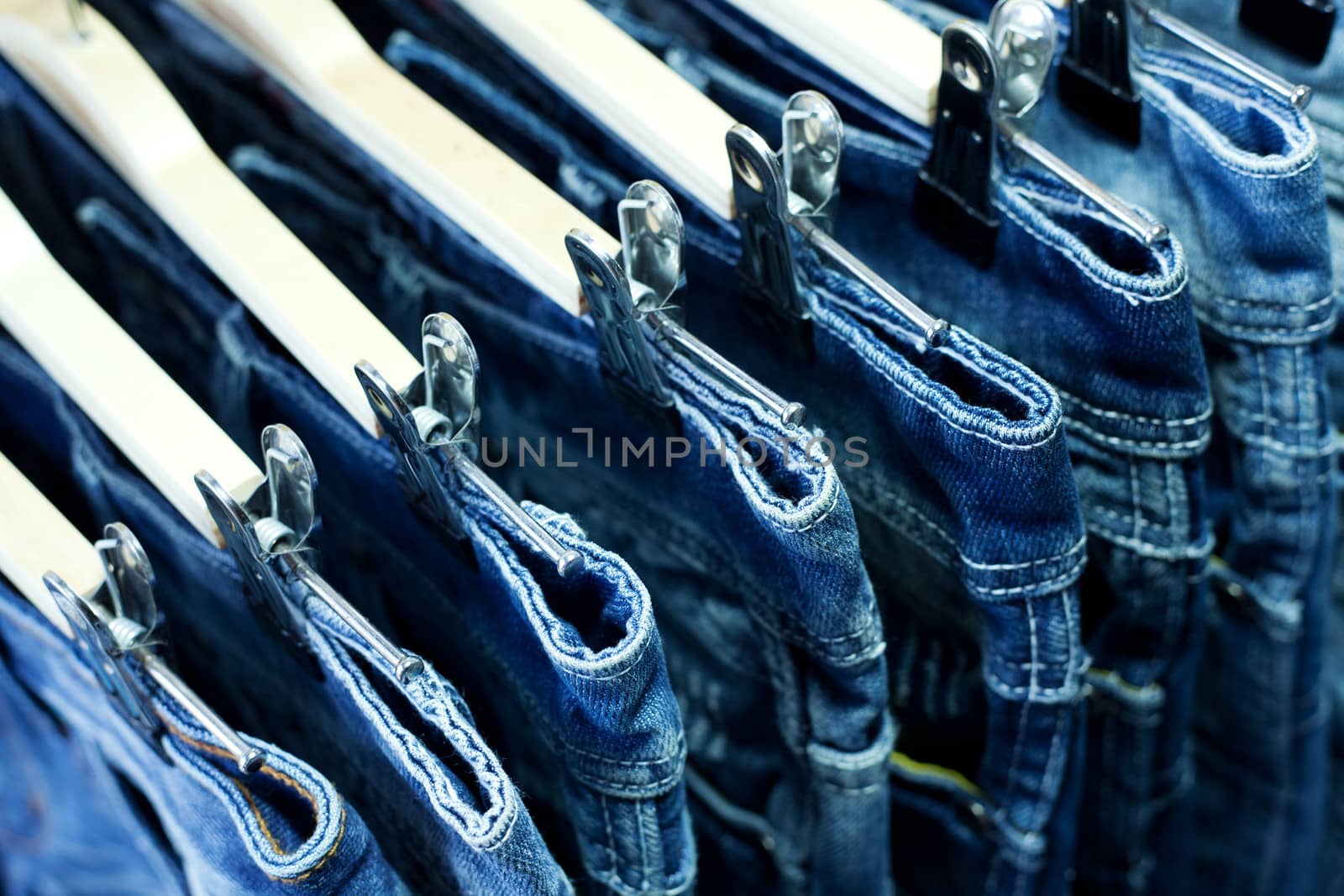 Row of hanged blue jeans