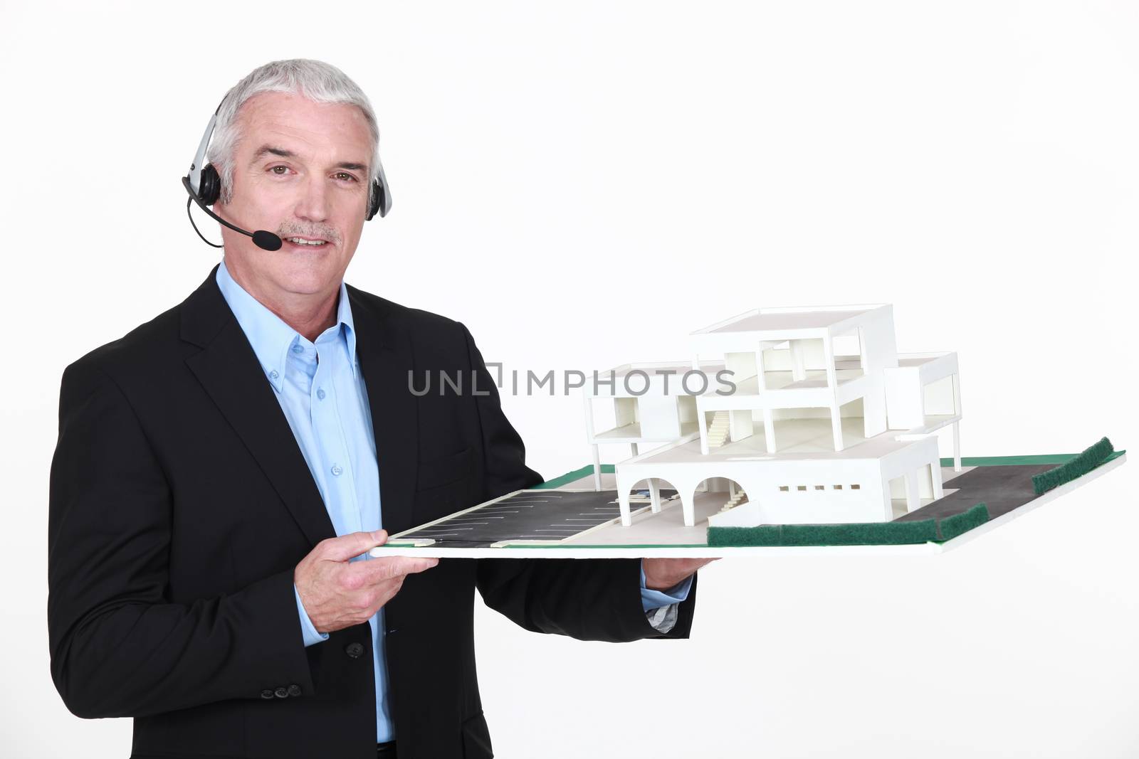 Architect holding replica of housing by phovoir