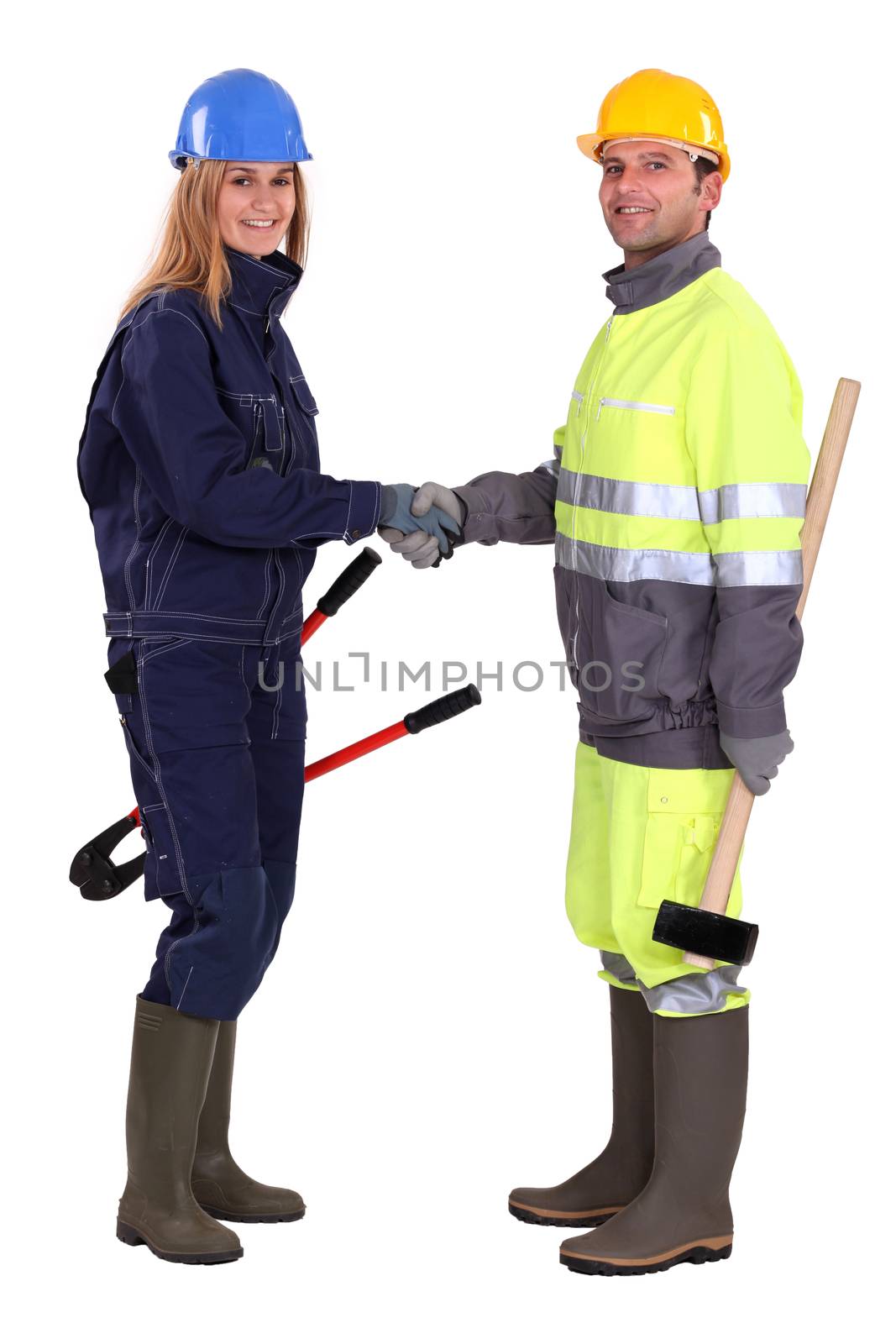 Construction workers shaking hands by phovoir