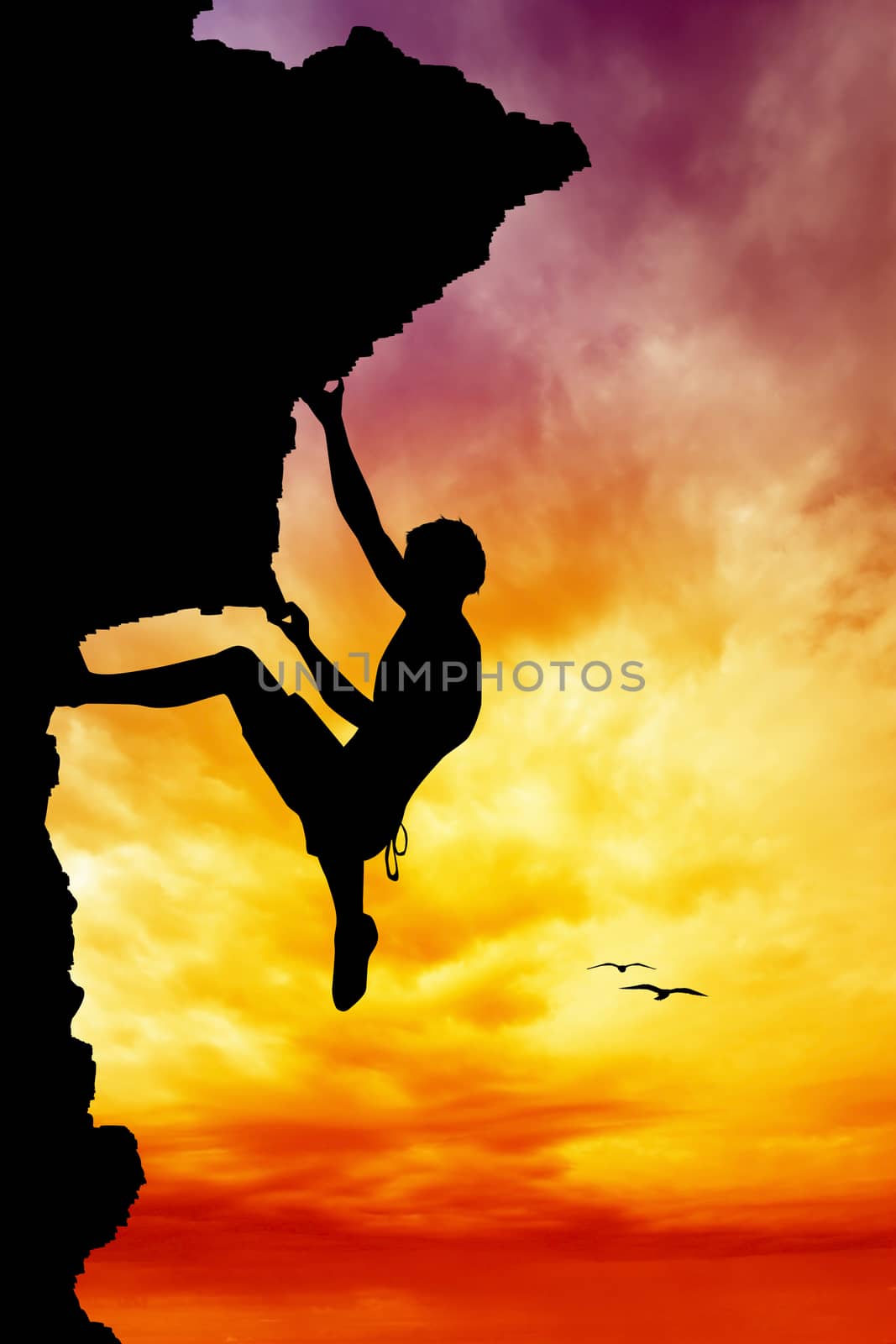 Free climber silhouette at sunset