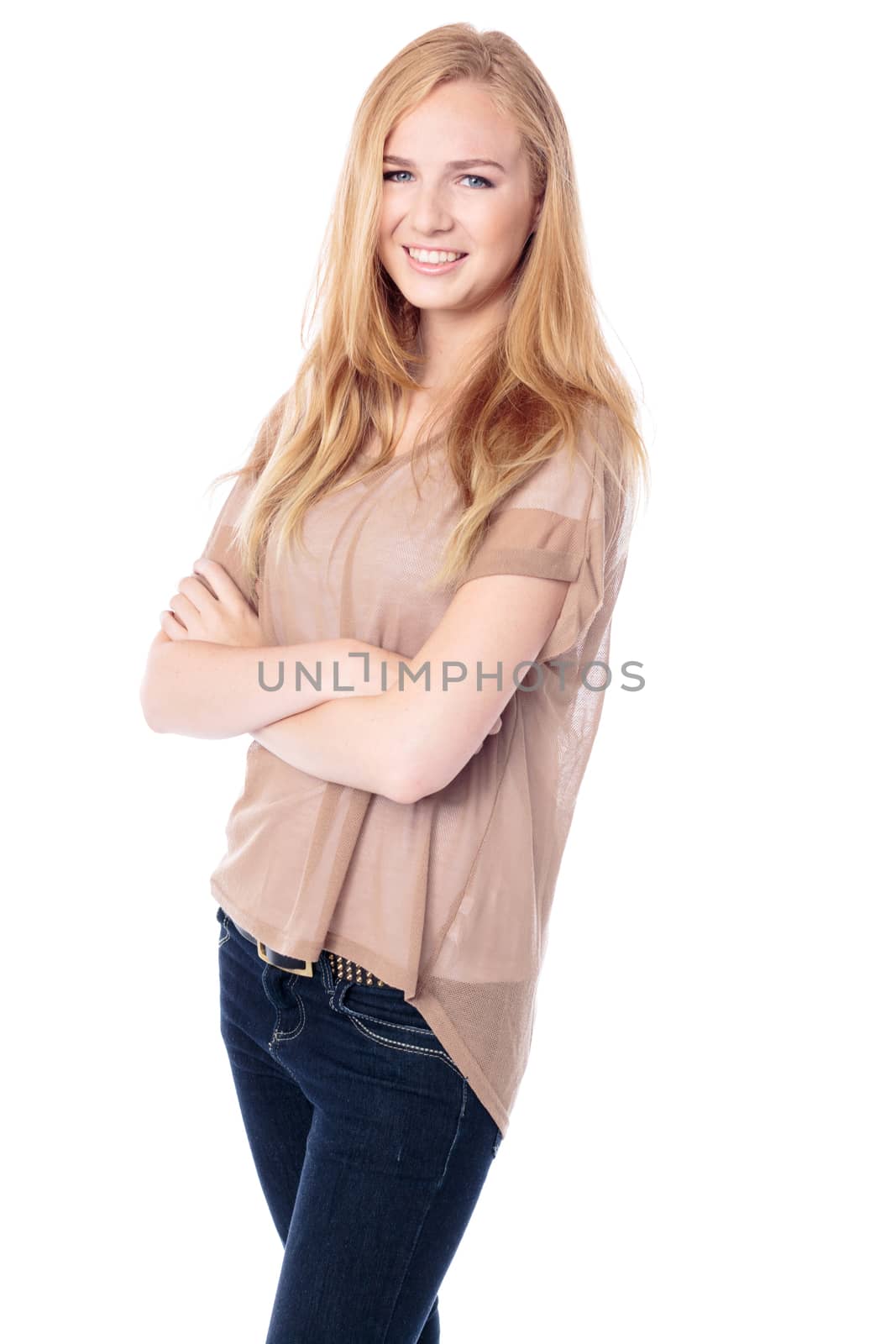 Smiling relaxed casual woman with long straight blond hair standing with her arms folded, three quarter portrait on white