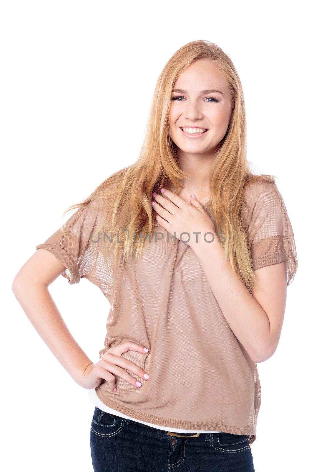 Friendly relaxed young woman standing with her hand on her hip giving the camera a beautiful smile, upper body on white