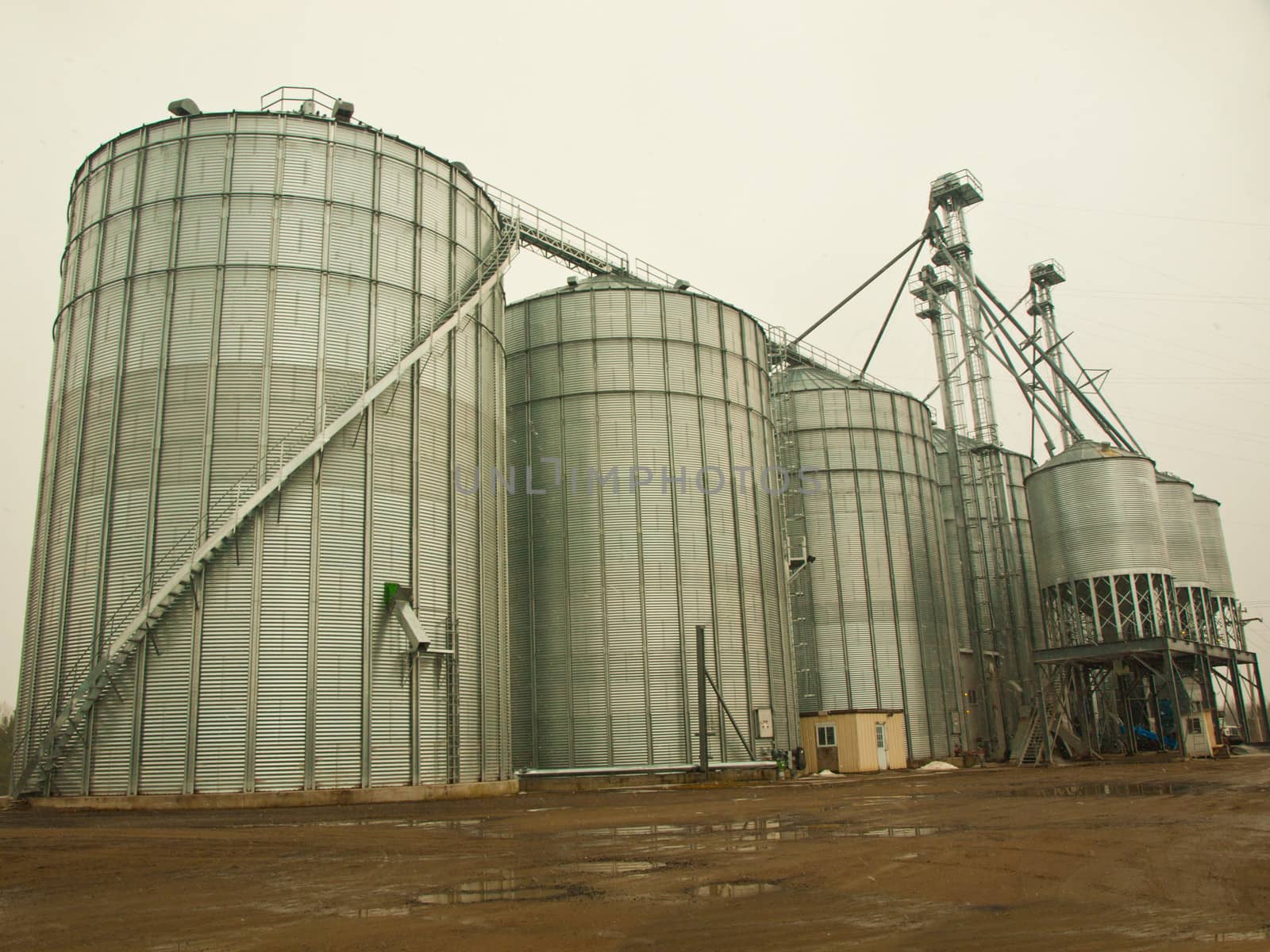 worksite with industrial silos on a rainy day